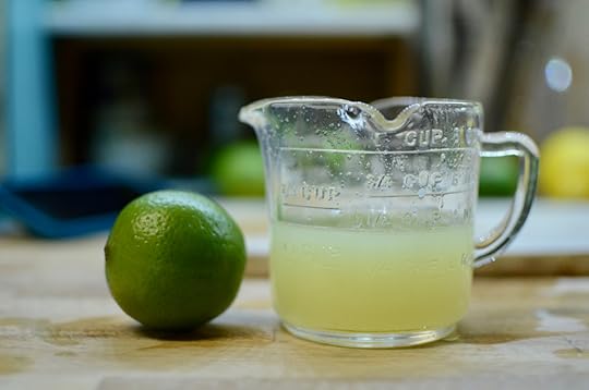 Lime and lime juice in a measuring cup.