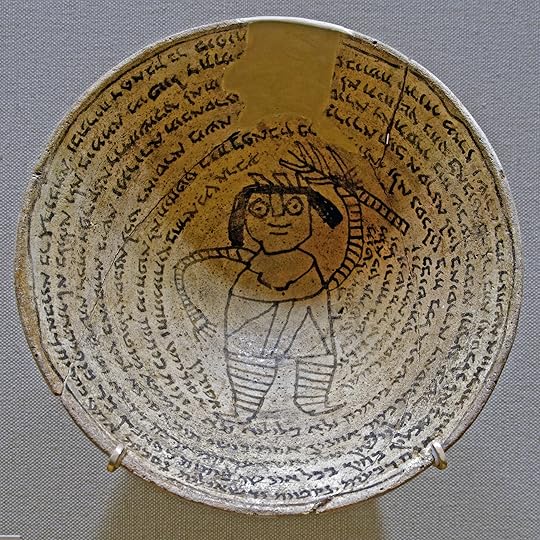 Mesopotamian Incantation bowl with an Aramaic inscription around a demon.