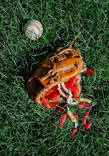 A baseball glove filled with candy and a baseball lying beside it as an illustration of David