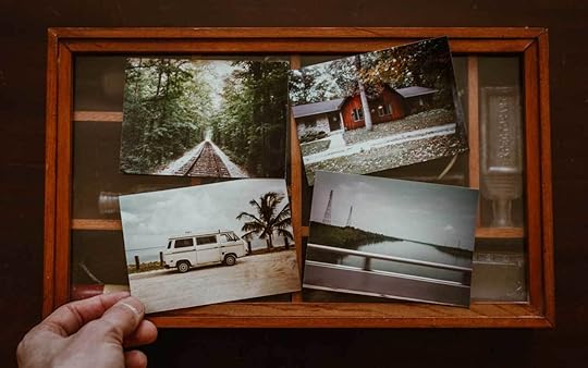 A shadow-box with four travel photos sitting on top.