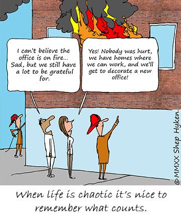 Office building on fire with employees outside talking