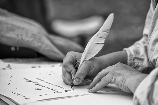 Man writing with quill on paper