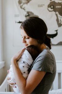 Ditch mom-guilt. Mom holding a baby