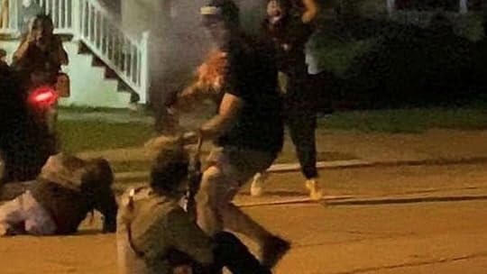 Kyle Rittenhouse on the ground shooting someone about ti attack him