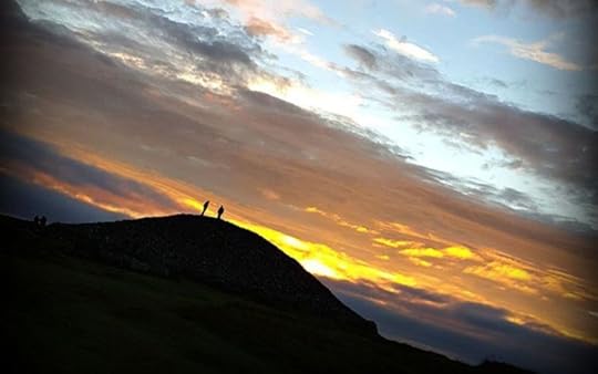 Image of two people standing atop one of the cairns at Loughcrew, County Meath, Ireland