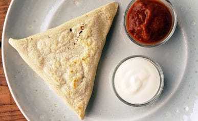 Mexican tetelas with salsa and crema