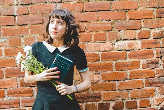 Me holding a book of poetry by Edgar Allan Poe