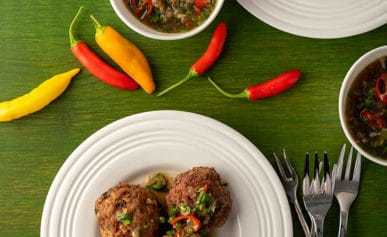 Thai meatballs with dipping sauce on appetizer plates