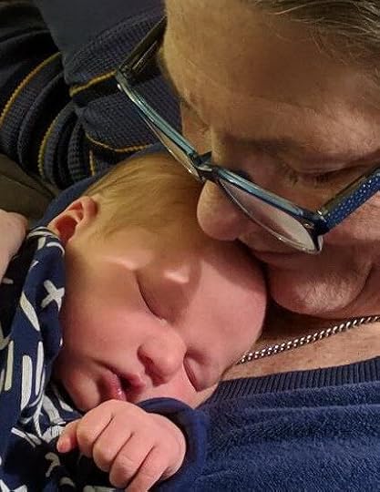 A child sleeps on grandma's chest