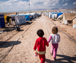 Refugee camp with kids o nroad with tents