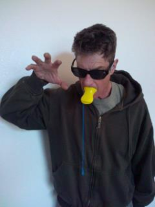 Photo of Mike Baron making a claw with his hand.