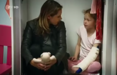 Pia sits in a closet next to a little girl
