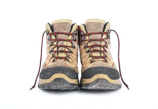 Dirty hiking boots on a white background