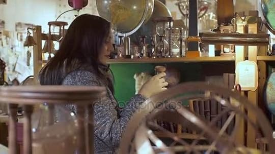 Young woman in antique shop looking curious an hourglass — Stock Video © videodream #138341476
