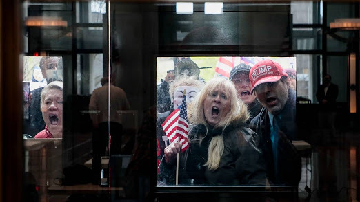 Photo of angry white assholes demanding to be allowing into a store so that they can spread coronavirus.