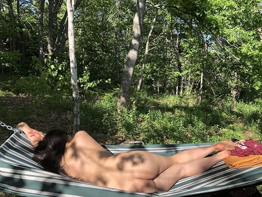 May Ling Su sunbathes nude in a hammock in the woods