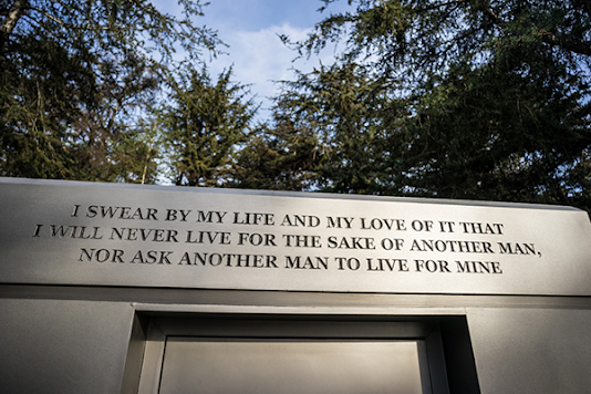 Atlas Shrugged movie photo; mausoleum engraved "'I swear by my life and my love of it that I will never live for the sake of another man, nor ask another man to live for mine"