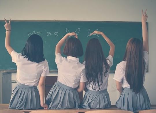 Image: a crew of four schoolgirls, sitting with their backs to the camera