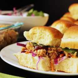 sweet and sour pulled chicken on hawaiian rolls on plate