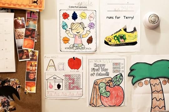 Image of a child's kindergarten assignments on the wall.