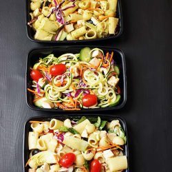 black meal prep containers with different pasta salads