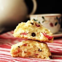 broken scone half balanced on another on red cloth