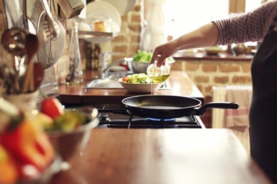 home cook drizzling extra virgin olive oil in a pan