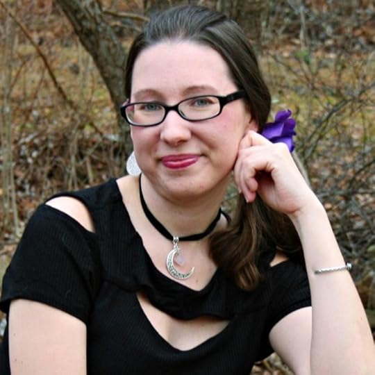 A person wearing glasses and smiling at the camera<br /><br />Description automatically generated