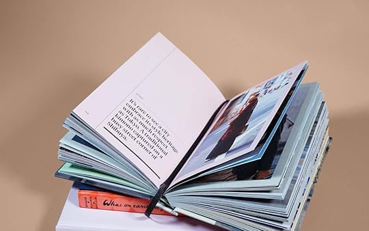 An open book with a bookmark sits on top of a stack of books. Anthony's dissertation defense was helped by his ability to mentally 