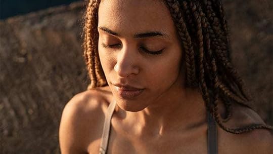 close-up of young woman meditating on a beach