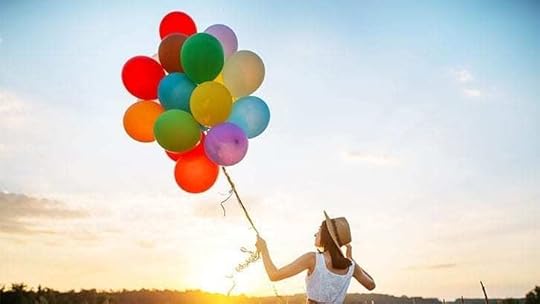 woman holding many balloons