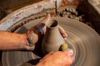 Potter throwing on the wheel.