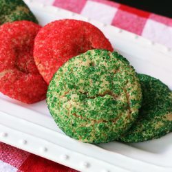 close up of green cookie on platter of sugar cookies