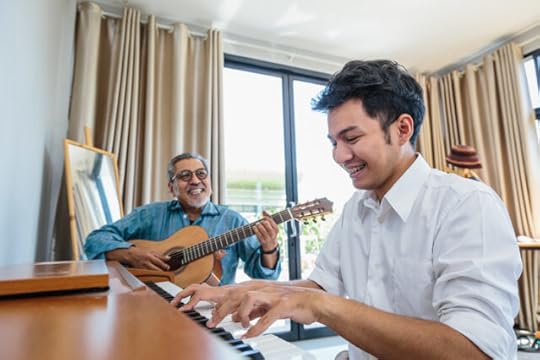 father and son playing music together