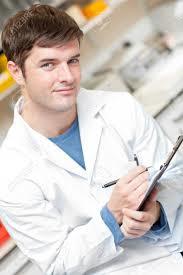 Handsome Scientist Holding A Clipboard And Smiling At The Camera Stock Photo, Picture And Royalty Free Image. Image 10245004.