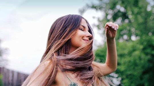 young woman dancing with her eyes closed
