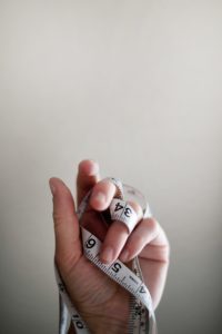 hand with tape measure