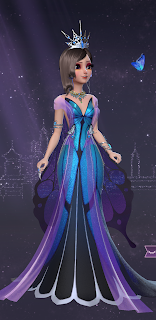 Princess Helen in an iridescent blue and purple butterfly gown with oversized wings and a grand silver crown