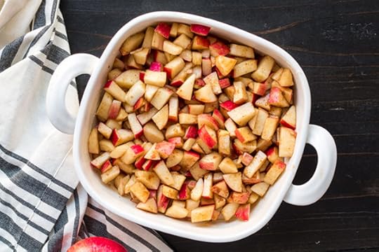 cinnamon and coconut sugar coated apples layered into a baking dish for apple dump cake