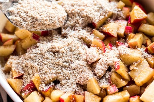 layering dry ingredients over diced apples with coconut sugar and cinnamon for apple dump cake