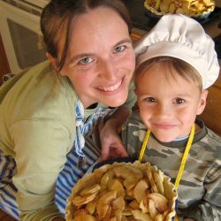 mother and boy holding apple pie they made together