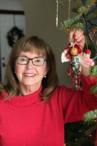 Elinor Florence with traditional Christmas tree