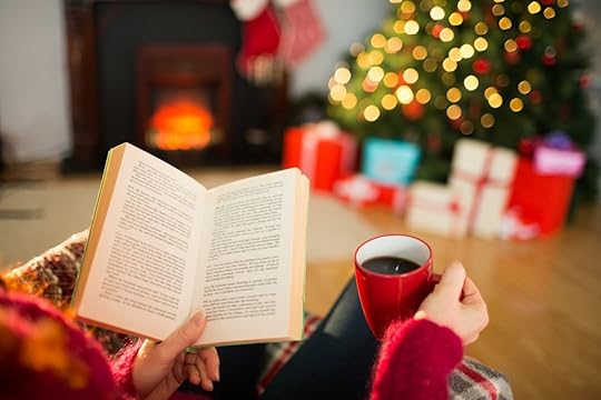Reading a book by a Christmas tree