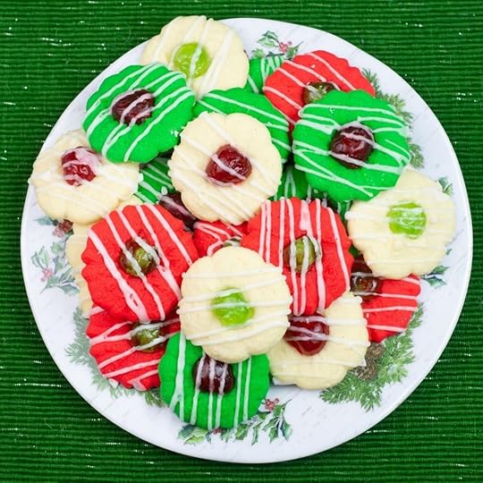 Red, green and white Christmas Spritz cookies on a holiday plate.