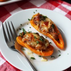 appetizer plate with two halves of sausage pepper and fork
