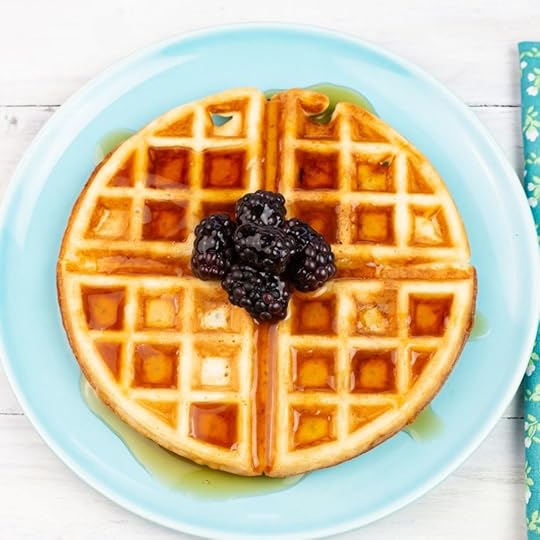 Sourdough waffles drizzled with syrup on a plate.
