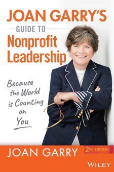 Photo of the cover of Joan Garry's Guide to Nonprofit Leadership featuring a color photo of Joan Garry, a white woman in a white top with a navy blue jacket. She has a beautiful smile. 