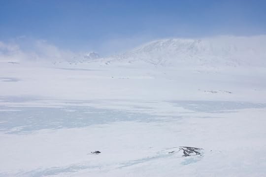 The horrors of that return journey are blurred to my memory and I know they were blurred to my body at the time. I think this applies to all of us, for we were much weakened and callous. The day we got down to the penguins I had not cared whether I fell into a crevasse or not. We had been through a great deal since then. ... I know that when it was only -40° when we camped for the night we considered quite seriously that we were going to have a warm one, and that when we got up in the morning if the temperature was in the minus sixties we did not inquire what it was. The day's march was bliss compared to the night's rest, and both were awful. We were about as bad as men can be and do good travelling: but I never heard a word of complaint, nor, I believe, an oath, and I saw self-sacrifice standing every test. [295-6] In civilization men are taken at their own valuation because there are so many ways of concealment, and there is so little time, perhaps even so little understanding. Not so down South. These two men went through the Winter Journey and lived: later they went through the Polar Journey and died. They were gold, pure, shining, unalloyed. Words cannot express how good their companionship was. Through all these days ... the worst I suppose in their severity that men have ever come through alive, no single hasty or angry word passed their lips. When ... we were sure, so far as we can be sure of anything, that we must die, they were cheerful, and so far as I can judge their songs and cheery words were quite unforced. Nor were they ever flurried, though always quick as conditions would allow in moments of emergency. It is hard that often such men go first when others far less worthy remain. [246] ... [W]ith quiet perseverance, in perfect friendship, almost with gentleness those two men led on. I just did what I was told. [249] Their spirits rose as they came within sight of the familiar landforms of the Hut Point Peninsula. How good the memories of those days are. With jokes about Birdie's picture hat: with songs we remembered off the gramophone: with ready words of sympathy for frost-bitten feet: with generous smiles for poor jests: with suggestions of happy beds to come. We did not forget the Please and Thank you, which mean much in such circumstances, and all the little links with decent civilization which we could still keep going. I'll swear there was still a grace about us when we staggered in. And we kept our tempers – even with God. [296-7] The temperature rose as they hauled their sledge down off the ice shelf onto the sea ice, and yet more as they rounded Cape Armitage. The Discovery Hut gave them their first solid shelter in over a month, and no longer having to eke out their last can of oil, they pitched a clean dry tent inside the hut and lit two Primus stoves inside it for maximum warmth, and drank cocoa without sugar so thick that next morning we were gorged with it. [297] The next day they did their final march in to Cape Evans, into what felt like blazing light as the mountains had hidden the growing midday light on the horizon for the last week or more. As we began to gather our gear together to pack up for the last time, Bill said quietly, 