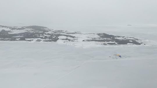The Cape Evans hut is the vaguely trapezoidal shape at left, surrounded by snowbanks; the camp on the ice is an Antarctica New Zealand experiment studying effects of different amounts and colours of light on sub-sea-ice diatoms.