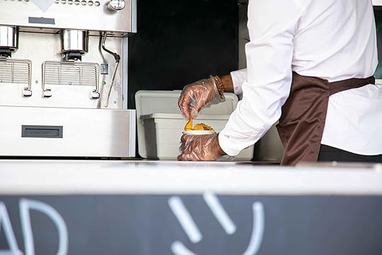 male chef preparing fried product at counter
